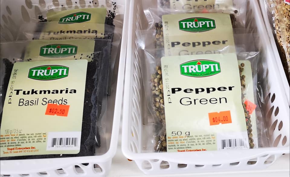 Display of African grocery products including canned goods and flours