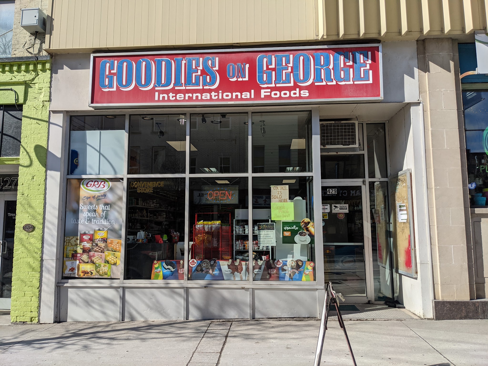Goodies On Mews storefront showing the International Foods sign and welcoming entrance
